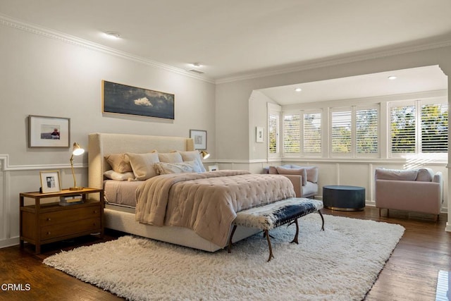 bedroom with dark hardwood / wood-style floors and ornamental molding