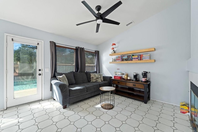 living room with ceiling fan and lofted ceiling