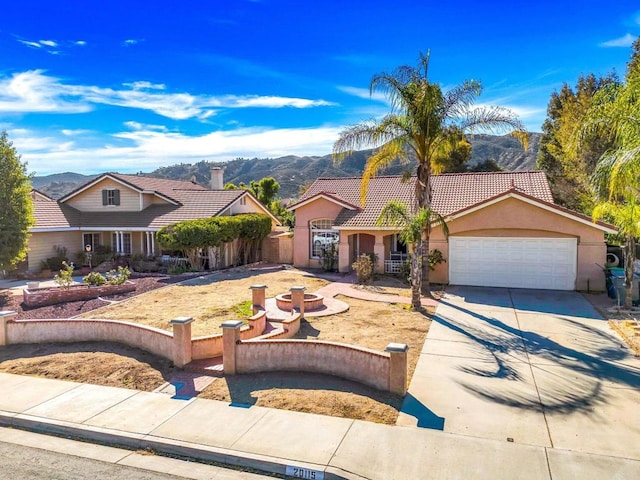 view of front of home featuring a mountain view and a garage