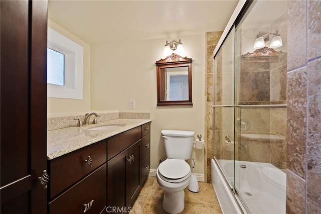 full bathroom featuring enclosed tub / shower combo, vanity, and toilet