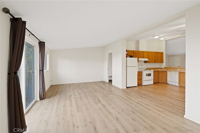 kitchen featuring white appliances and light hardwood / wood-style flooring