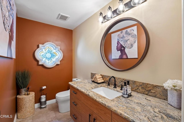 bathroom featuring tile patterned floors, vanity, and toilet