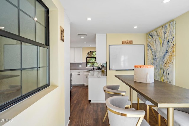 dining area with dark hardwood / wood-style floors and sink