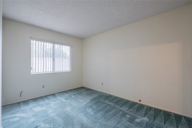 spare room with carpet floors and a textured ceiling