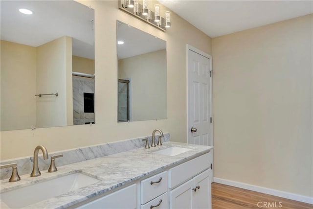 bathroom with vanity, a shower, and hardwood / wood-style floors