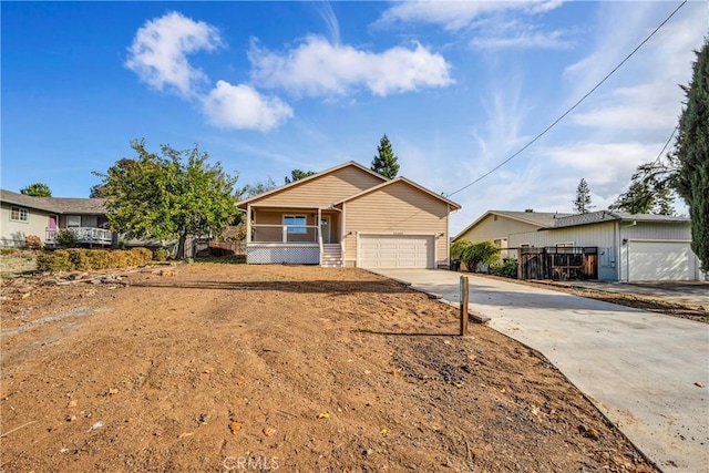 ranch-style home with covered porch and a garage