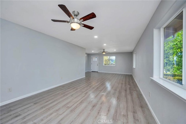 unfurnished living room featuring ceiling fan, a healthy amount of sunlight, and light hardwood / wood-style flooring