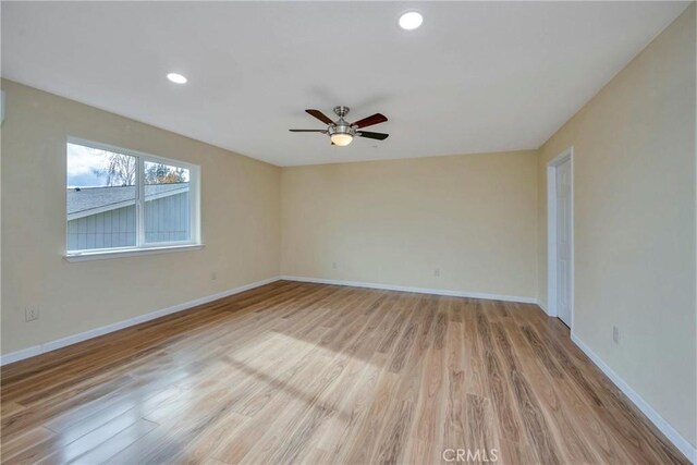 spare room featuring ceiling fan and light hardwood / wood-style floors