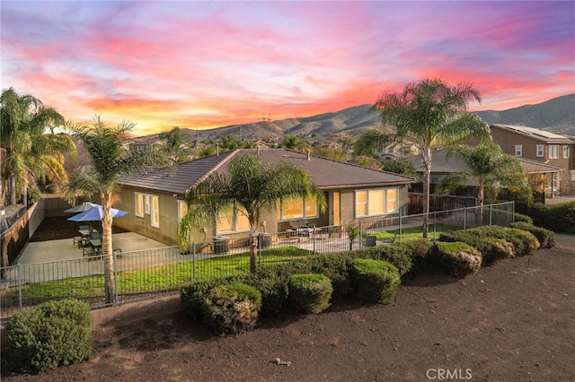 view of front of property featuring central AC, a mountain view, and a patio