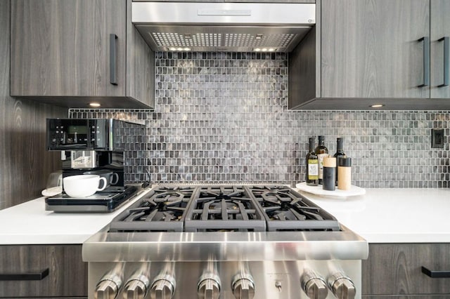 kitchen featuring dark brown cabinetry, decorative backsplash, and range hood