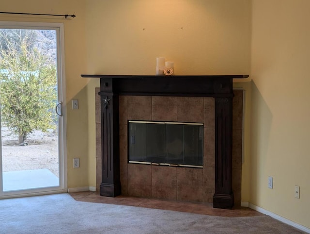 room details with carpet flooring and a tiled fireplace