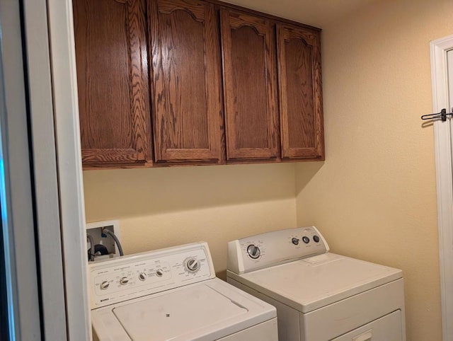 laundry area with cabinets and washing machine and dryer