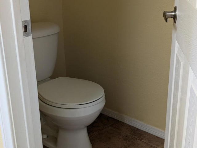 bathroom with tile patterned flooring and toilet