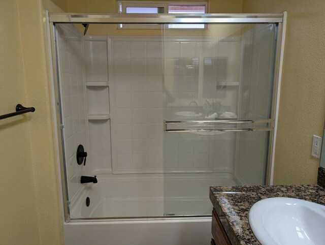 bathroom with vanity and bath / shower combo with glass door