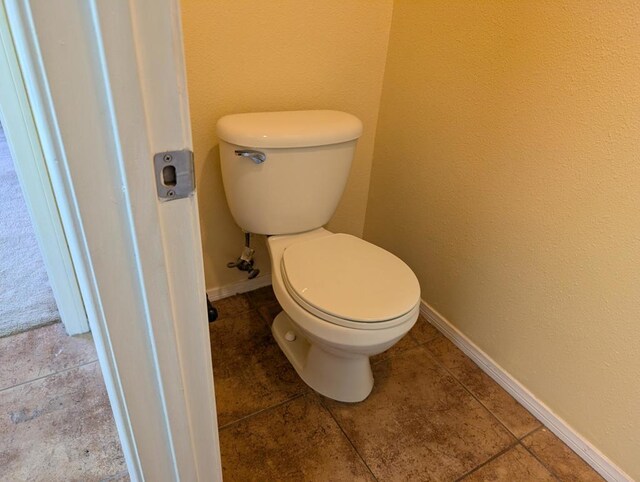 bathroom with tile patterned floors and toilet