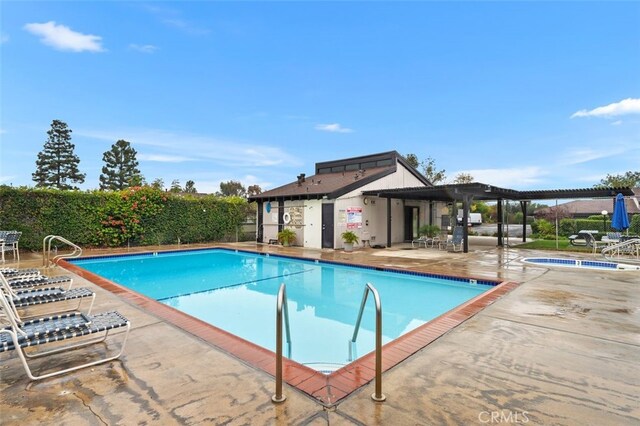 view of pool featuring a community hot tub and a patio