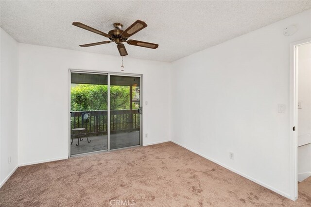 carpeted empty room with ceiling fan and a textured ceiling