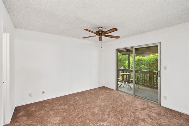 spare room with ceiling fan, carpet, and a textured ceiling