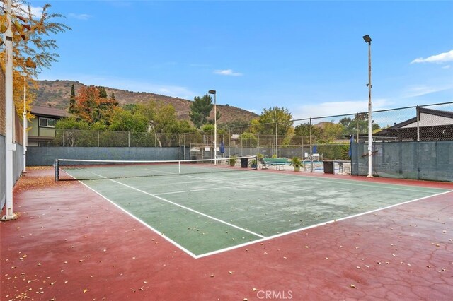 view of sport court with a mountain view