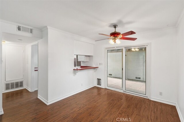 empty room featuring ceiling fan, dark hardwood / wood-style flooring, and ornamental molding