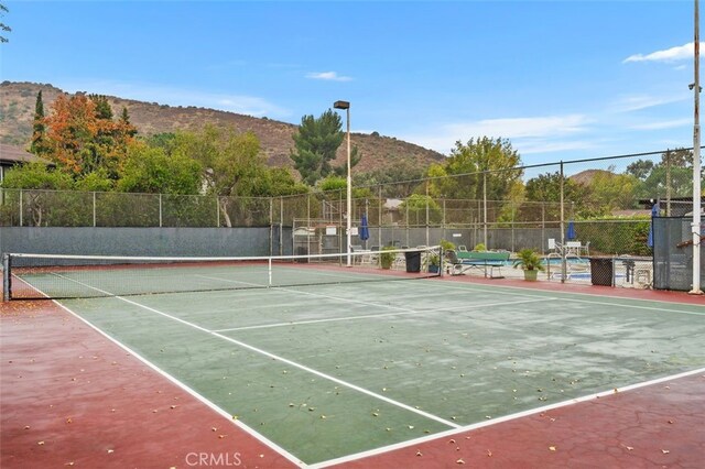 view of sport court with a mountain view