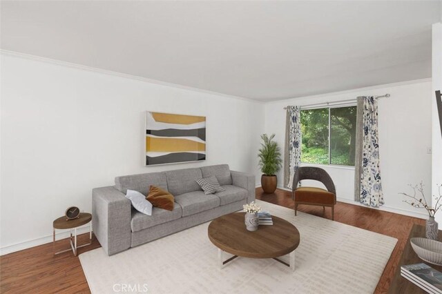 living room with hardwood / wood-style floors and ornamental molding