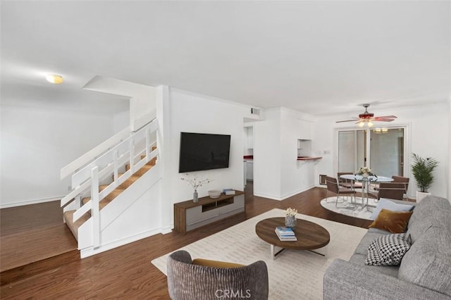 living room featuring ceiling fan and dark hardwood / wood-style flooring