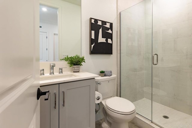 bathroom with an enclosed shower, vanity, and toilet