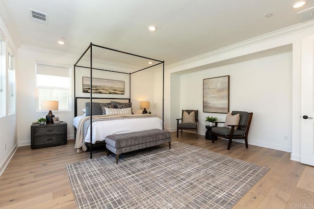 bedroom featuring crown molding and light wood-type flooring