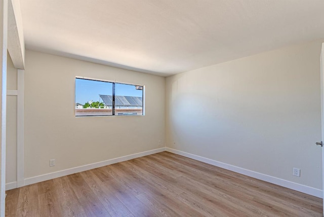 empty room with light hardwood / wood-style flooring