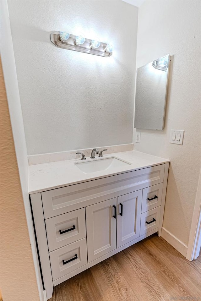 bathroom featuring wood-type flooring and vanity