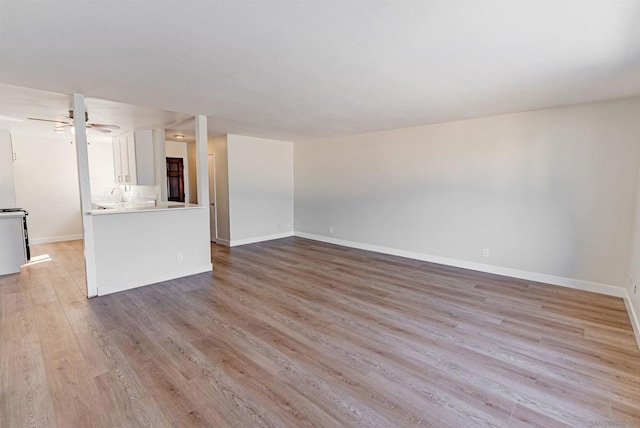 unfurnished living room with light hardwood / wood-style floors and ceiling fan