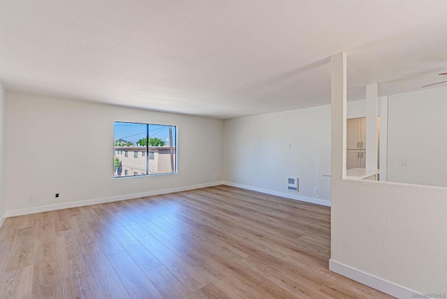 unfurnished room with ceiling fan and light hardwood / wood-style floors