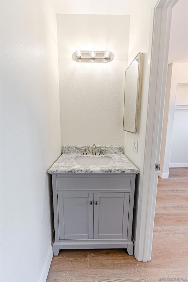 bathroom with vanity and hardwood / wood-style flooring