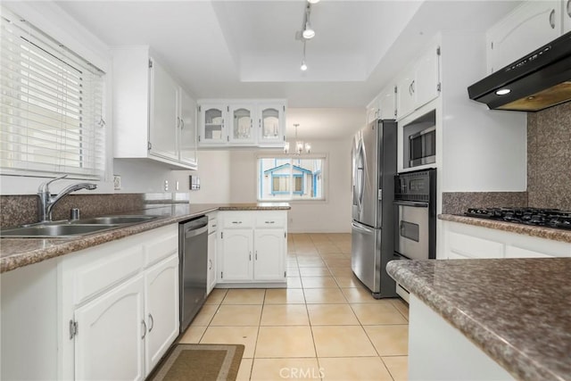 kitchen featuring a wealth of natural light, sink, white cabinets, and black appliances