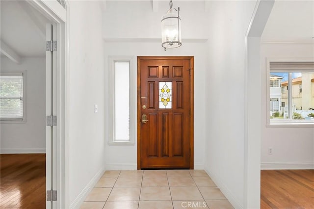 foyer with a notable chandelier and light wood-type flooring