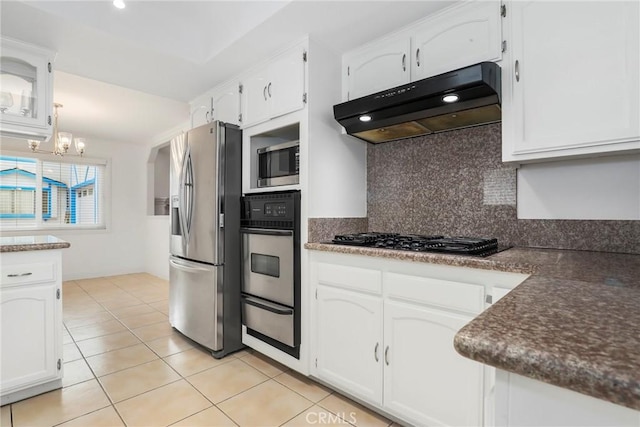 kitchen with pendant lighting, white cabinets, decorative backsplash, light tile patterned floors, and stainless steel appliances