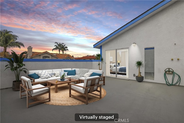 patio terrace at dusk with an outdoor hangout area