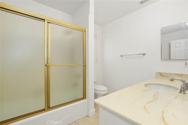 full bathroom with tile patterned floors, toilet, vanity, and combined bath / shower with glass door