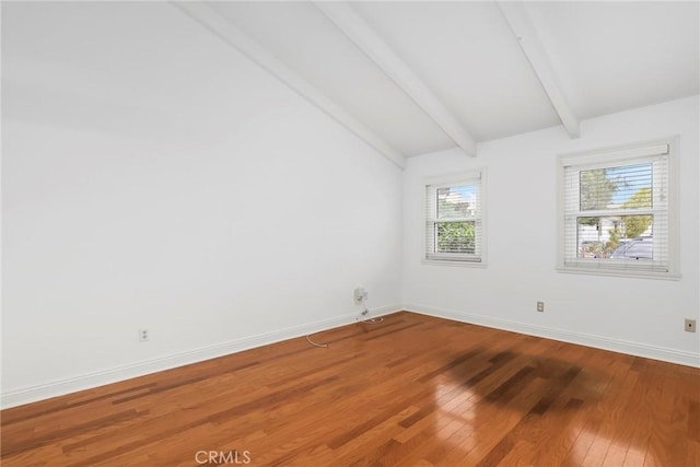 empty room with vaulted ceiling with beams and wood-type flooring