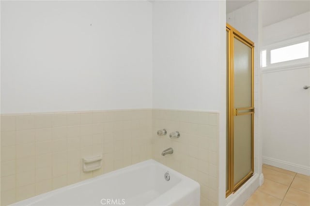 bathroom with tile patterned flooring and a bathing tub