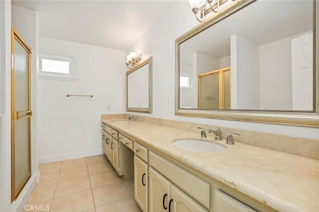 bathroom featuring tile patterned flooring, vanity, and a shower with shower door