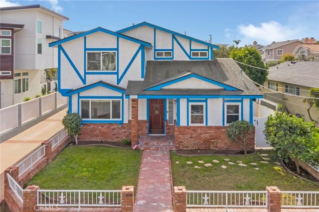 tudor home with a front yard