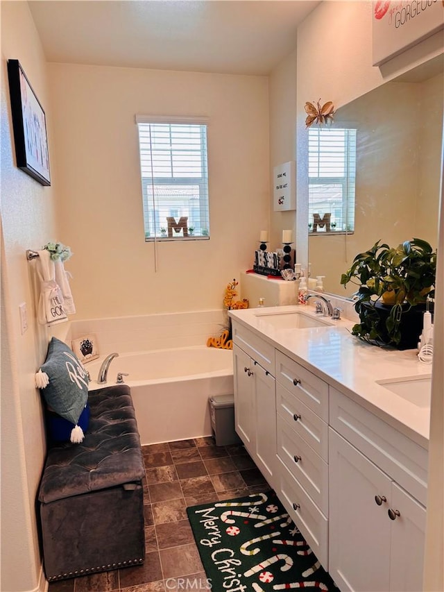 bathroom with a bathing tub and vanity