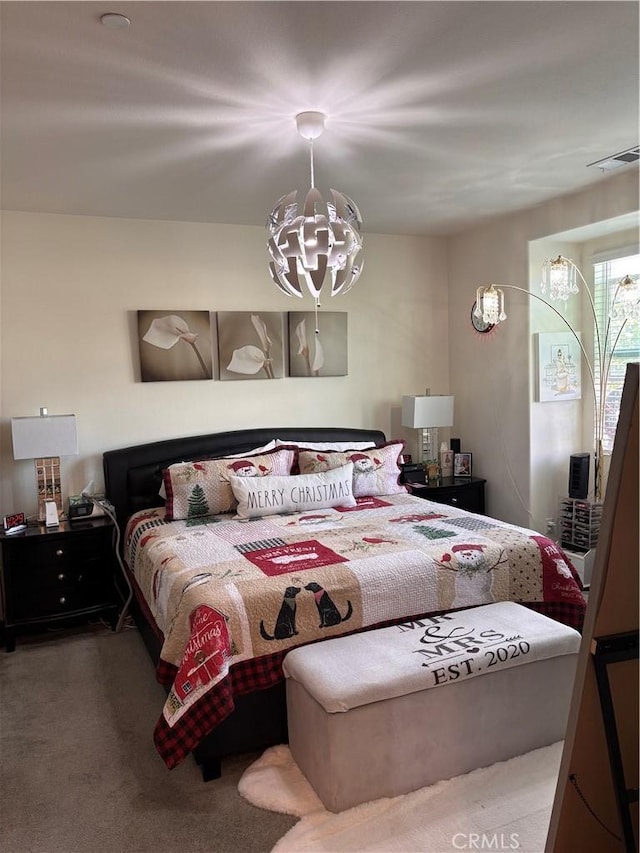 carpeted bedroom with a chandelier