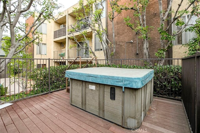 wooden terrace with a hot tub