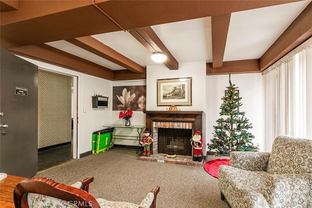 carpeted living room featuring beam ceiling, a healthy amount of sunlight, and a fireplace