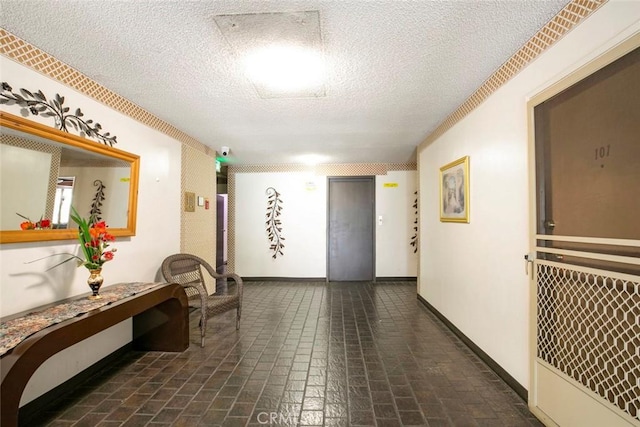 hall with a textured ceiling