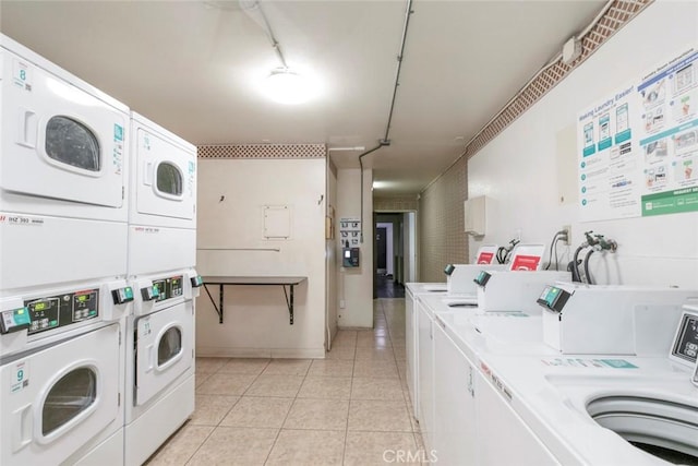 clothes washing area with independent washer and dryer, light tile patterned floors, and stacked washer / dryer