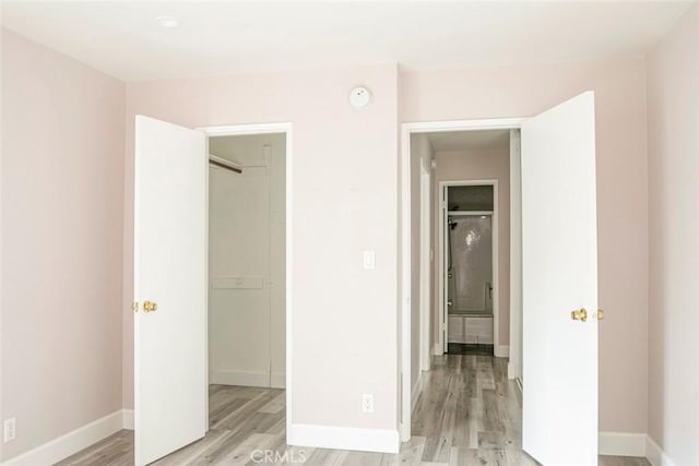 unfurnished bedroom featuring light wood-type flooring and a closet